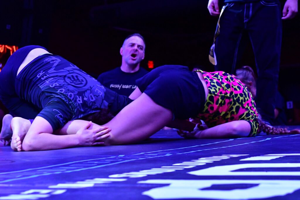 Cadence Glann securing the armbar finish using her strength & conditioning.  She can help you reach your goals via personal training & nutrition services.